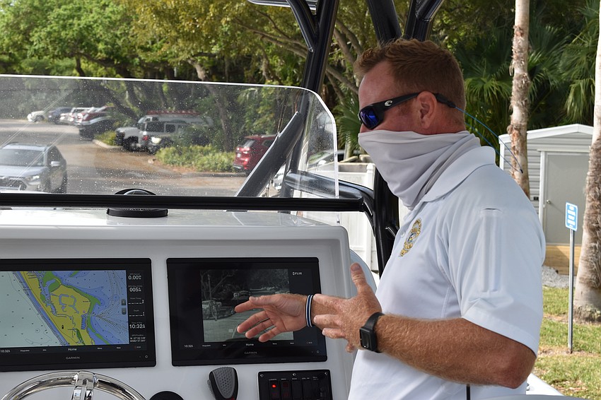 Marine patrol officer Joshua Connors demonstrates how the two Garmin displays are used on the police department's new boat.