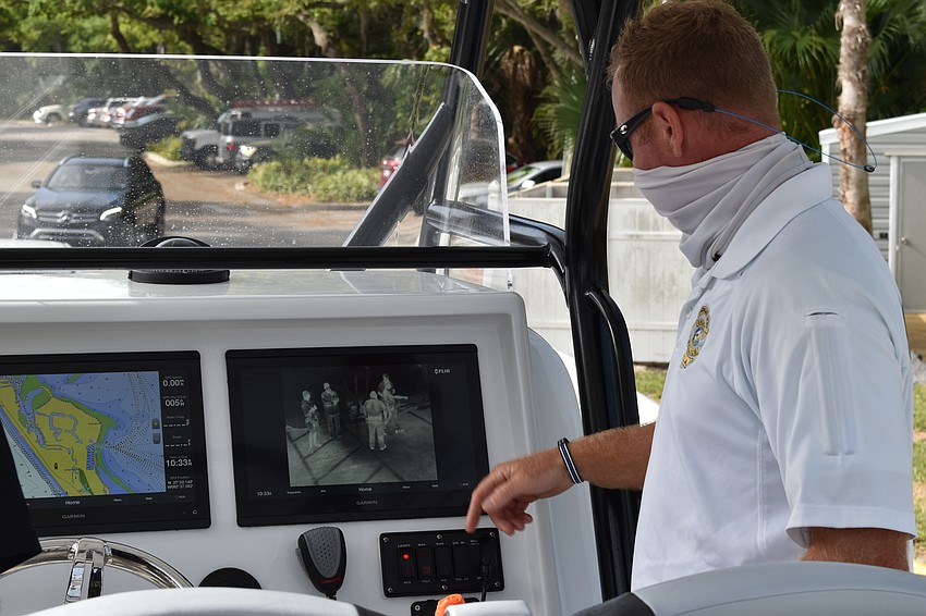 Marine patrol officer Joshua Connors demonstrates how the two Garmin displays are used on the police department's new boat.