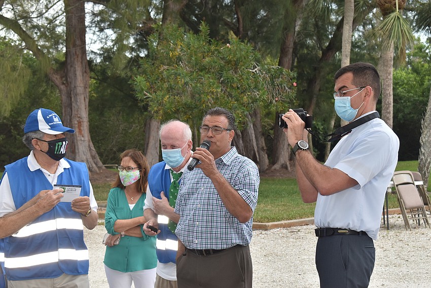 Father Robert Dziedziak, right, snaps photos as prizes are doled out.