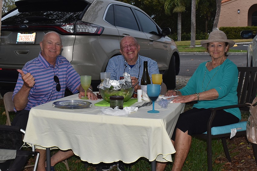 Steve Whitney, George Noble and Cindy Noble at their picnic setup.