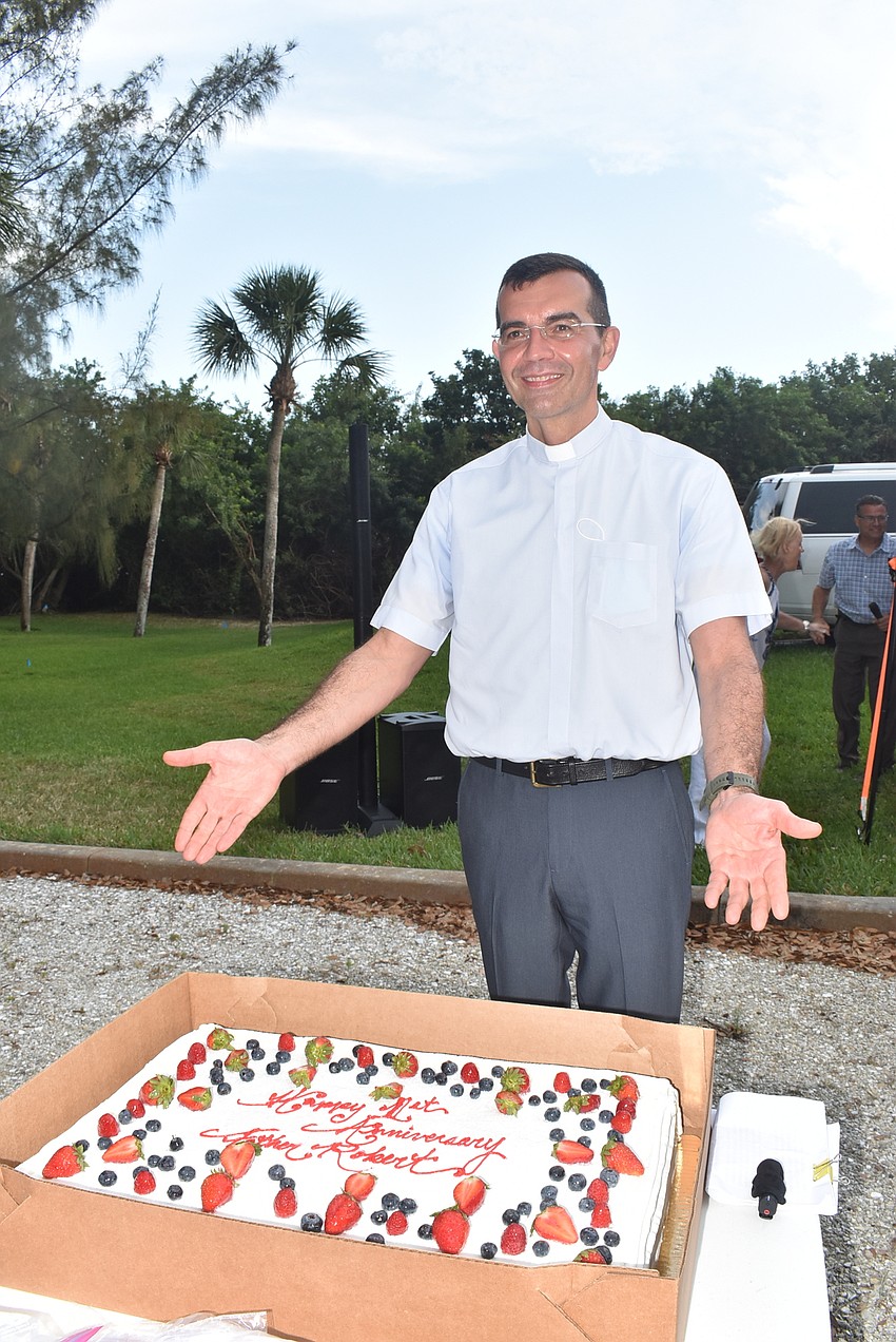 The leaders of the Men's and Women's Guilds got a one-year anniversary cake for Father Robert Dziedziak.