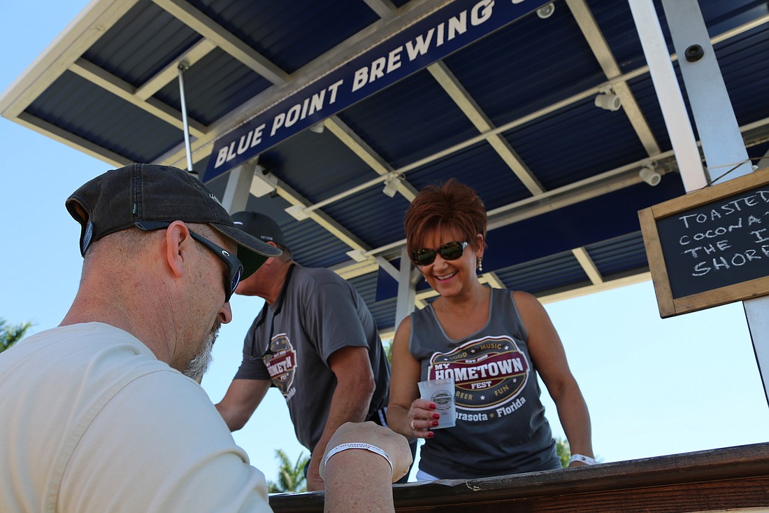 Kathy Cromley of Sertoma Club of Greater Sarasota pours a beer for a customer during My Hometown Fest in 2019. This year, the nonprofit is hosting My Hometown Jam, a smaller fundraiser than My Hometown Fest. Courtesy photo.