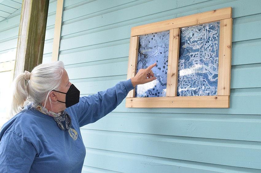 Denise Kleiner, the operator of Jiggs Landing, shows the development of Jiggs Landing on a map.