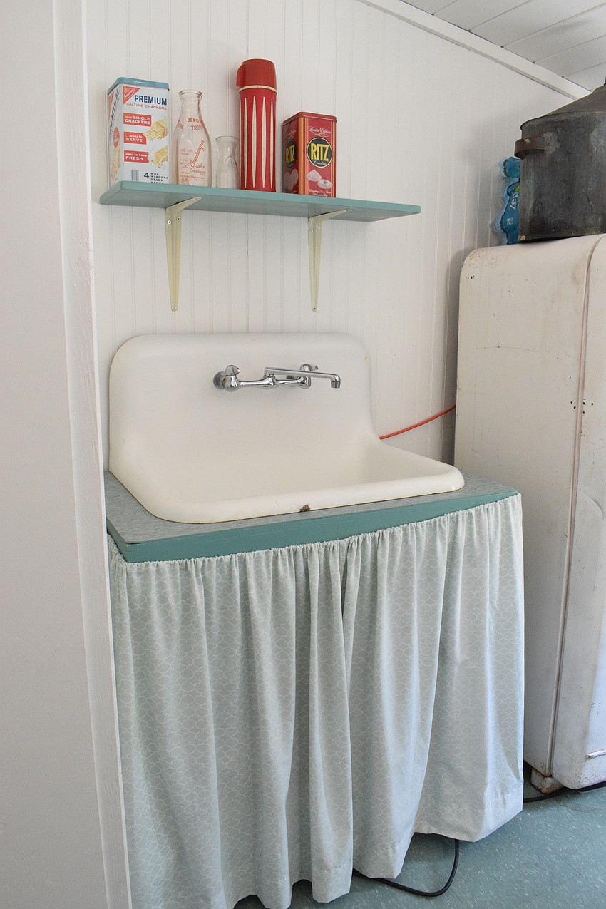 The replica cabin includes a sink that has space for storage underneath.
