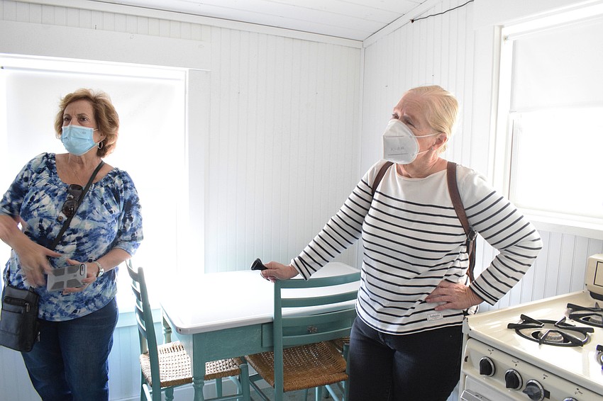 Lakewood Ranch's Francesca Tulski and Suzanne MacDonald enjoy a tour of the replica cabin at Jiggs Landing.
