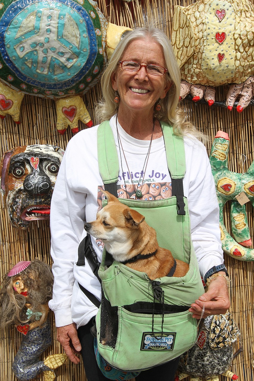 Paula Knudsen sells dog masks and other creations with her dog Mango at the Frumple Factory.