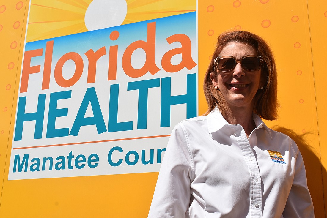 Country Club resident Dr. Jennifer Bencie, the Manatee County Health Officer for the Florida Department of Health, is pictured at the county&#39;s drive-thru vaccination site at Tom Bennett Park.