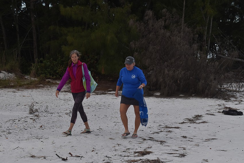 Cyndi Seamon and Cam Maddox head up the beach.