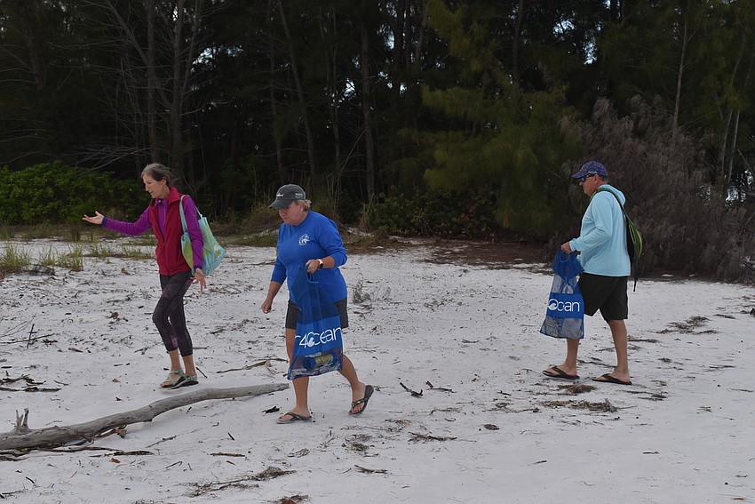 Cyndi Seamon, Cam Maddox and Brian Maddox head up the beach.