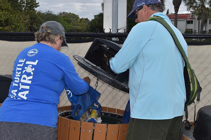 Cam and Brian Maddox discard their trash.