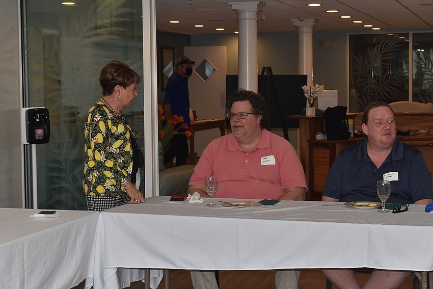 Carol Peschel introduces herself to Jeff and Michael Nunes.