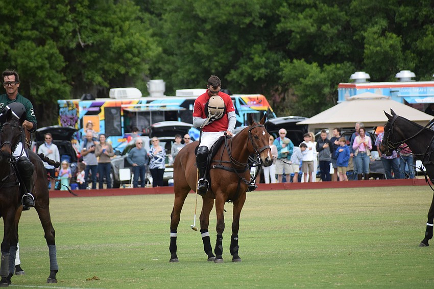 Hillcroft Farm's Mason Wroe bows his head during the National Anthem.