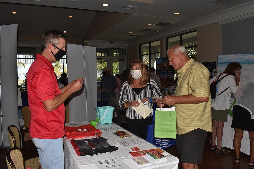 Jim Turk shows the Junk King table to Nancy and Chris Richard