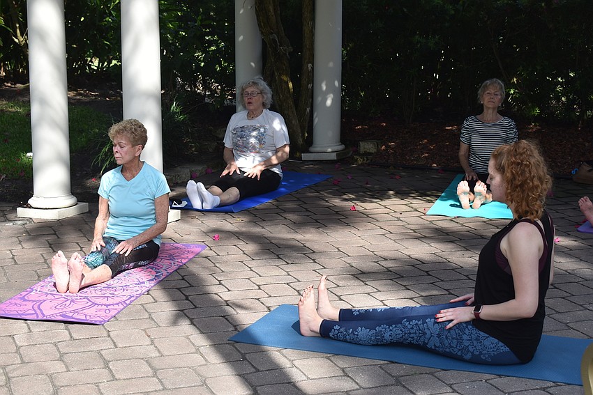 Marj Kirchner sits in staff pose as teacher Nina Vannucci described.