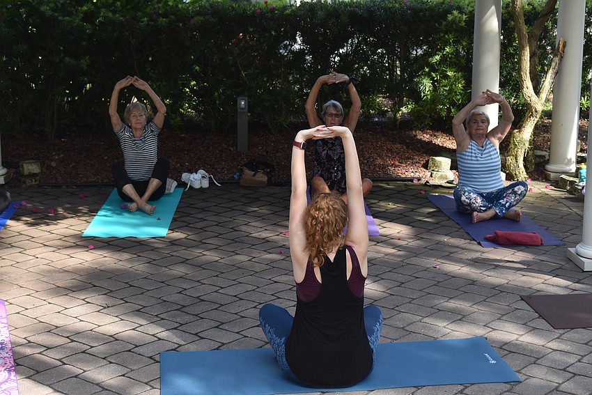 Nina Vannucci stretches in a seated pose.