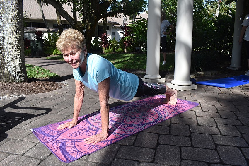 Marj Kirchner holds plank pose.