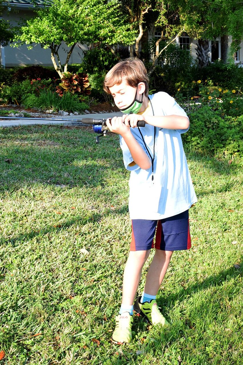 Bradenton's Ethan Tirado, who is 8, practices casting his line. Tirado came in third place in his age group at the Youth Fishing Tournament last year.