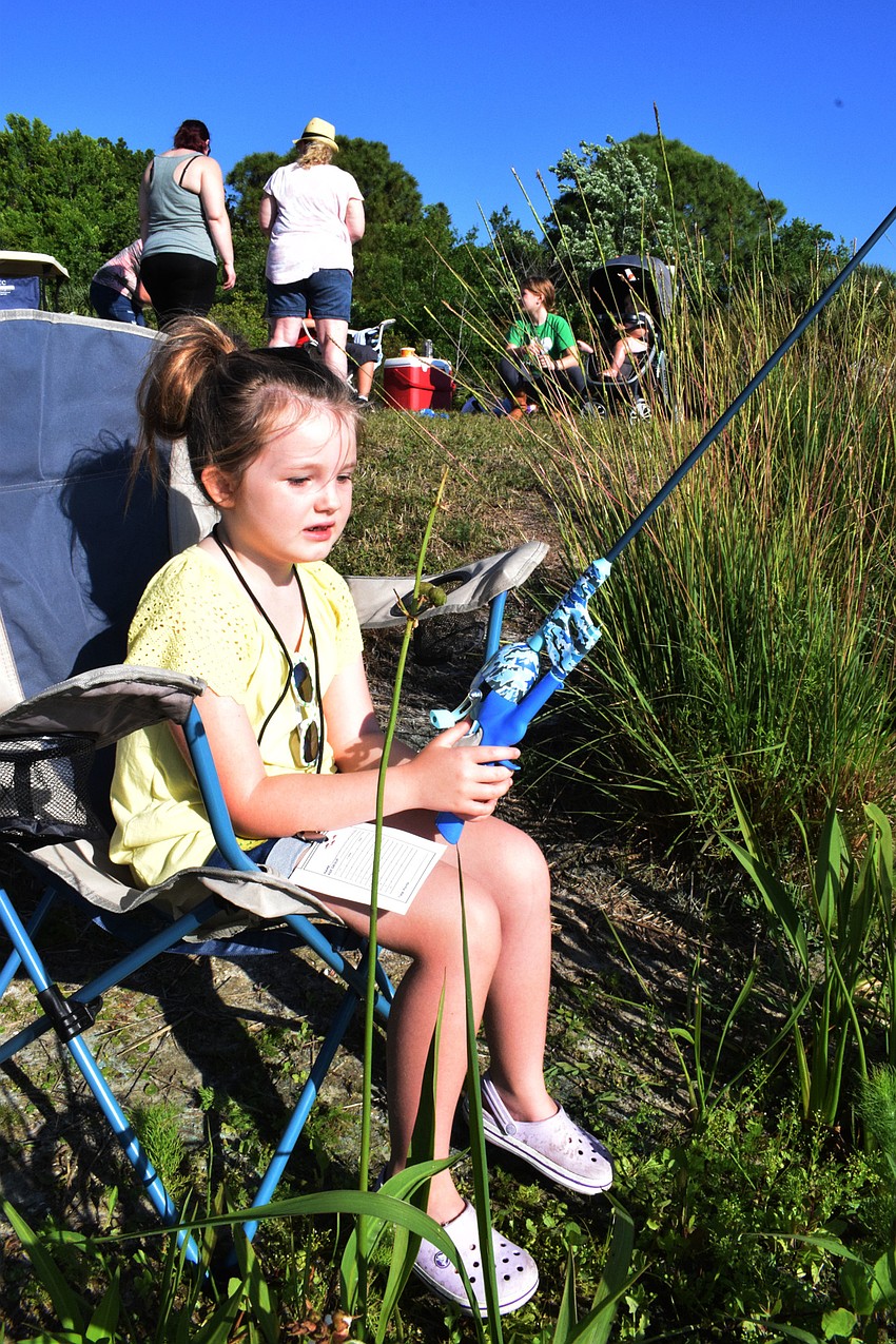 Sarasota's Allie Lipinski, who is 6, patiently waits to see if she will catch a fish.