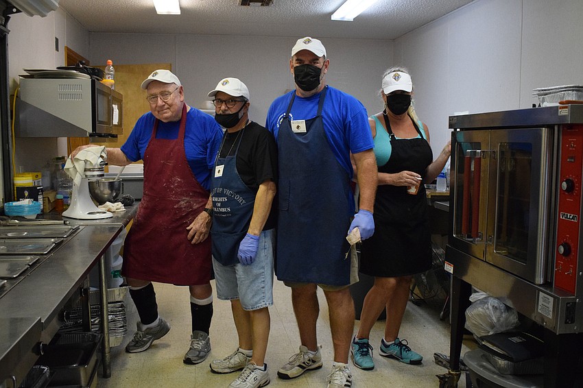 Rich Macklin, Tom Rokosz, Mike Mahan and Nancy Turk volunteer to make pancakes, french toast and sausage for families.
