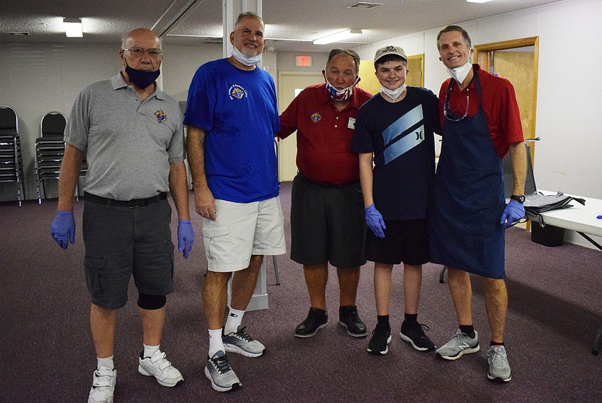 Don Castracani, Joe Melocchi, Mike Chapman, Ben Lento and Paul Lento help deliver breakfast foods to families as the food is made.