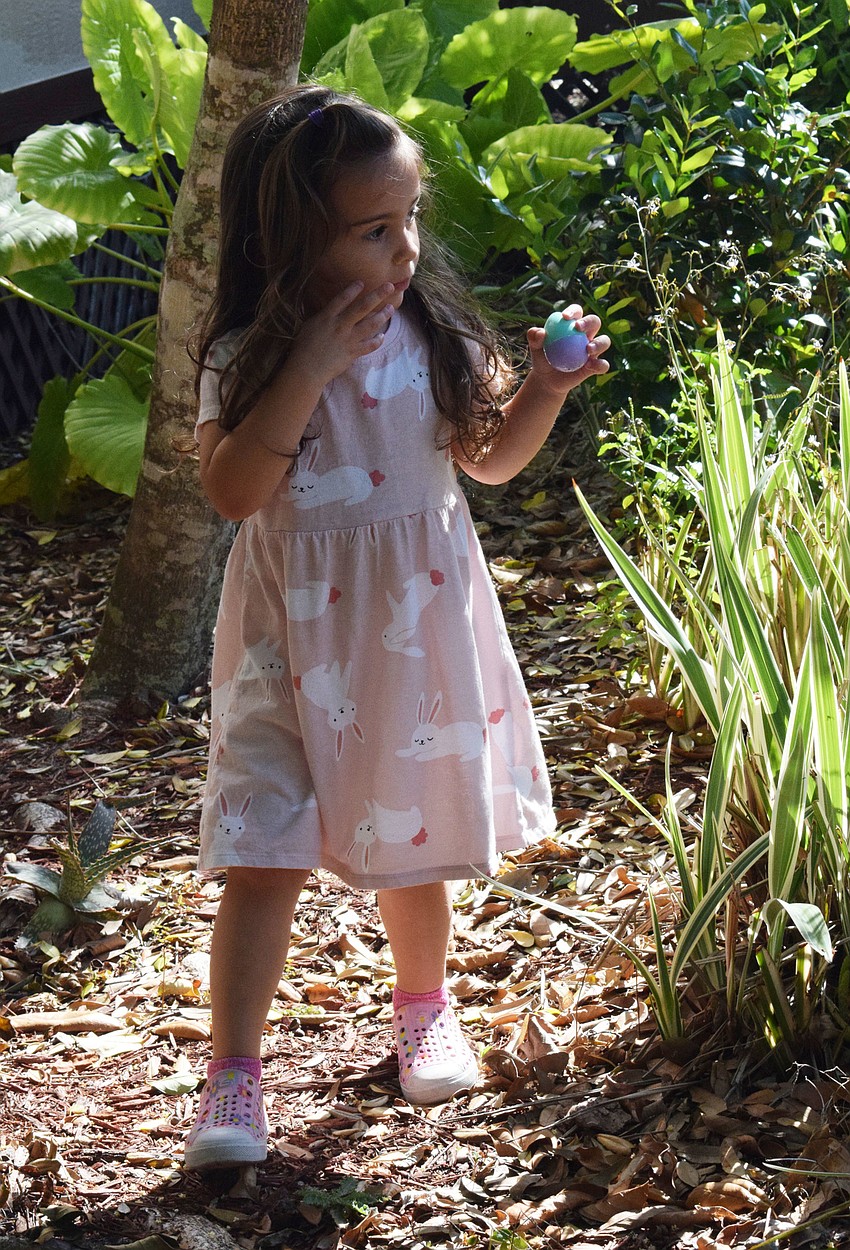 Lakewood Ranch's Delilah David, who is 3 years old, gets excited about finding an egg during the egg hunt.