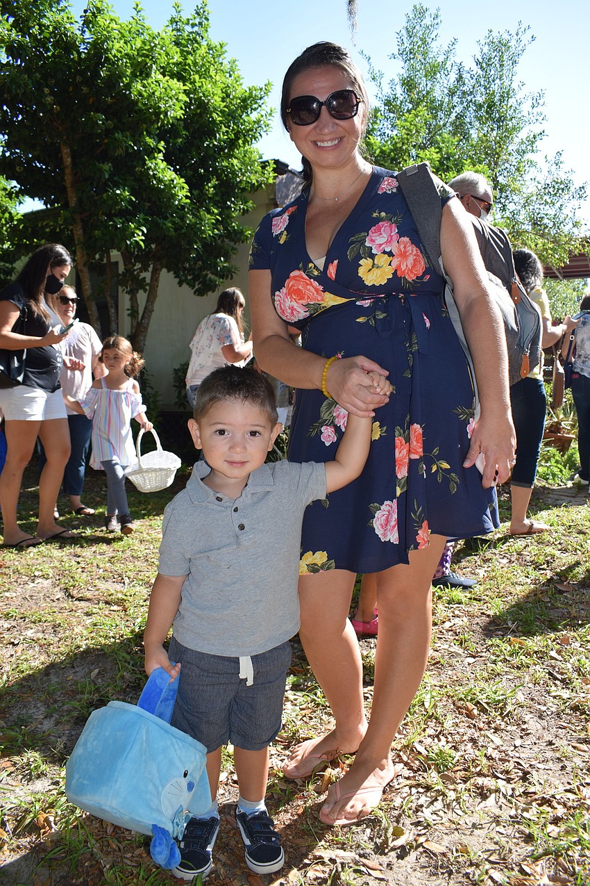 Greenbrook's Christine Castellon helps her 2-year-old son Mateo find eggs during the egg hunt.
