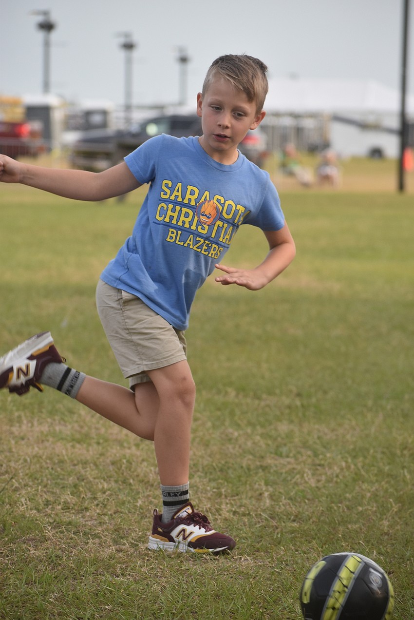 Sarasota resident Finnegan Agate, 7, plays soccer with his dad, CJ Agate, and sister, 6-year-old Atlas Agate. CJ Agate said he hoped the soccer would tire out his kids in time for bed.