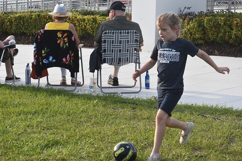 Sarasota resident Atlas Agate, 6, plays soccer with her dad, CJ Agate, and brother, 7-year-old Finnegan Agate. CJ Agate said he hoped the soccer would tire out his kids in time for bed.