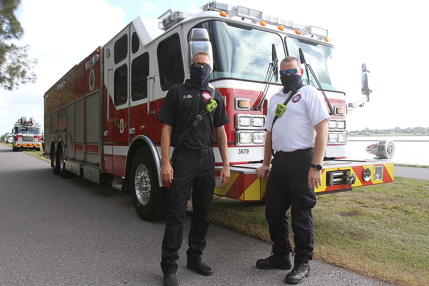 Mark Robins and Russ Nelson with a fire truck.