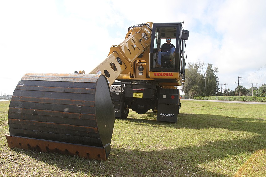 Sarasota County employees manage the Gradall truck.