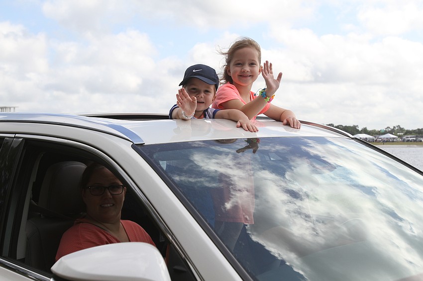 Lakewood Ranch residents Noah and Lyla Sherwin wave to people around them.
