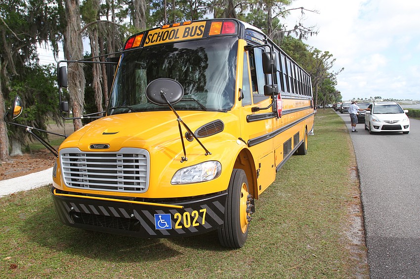 Families enjoy a Sarasota County school bus.