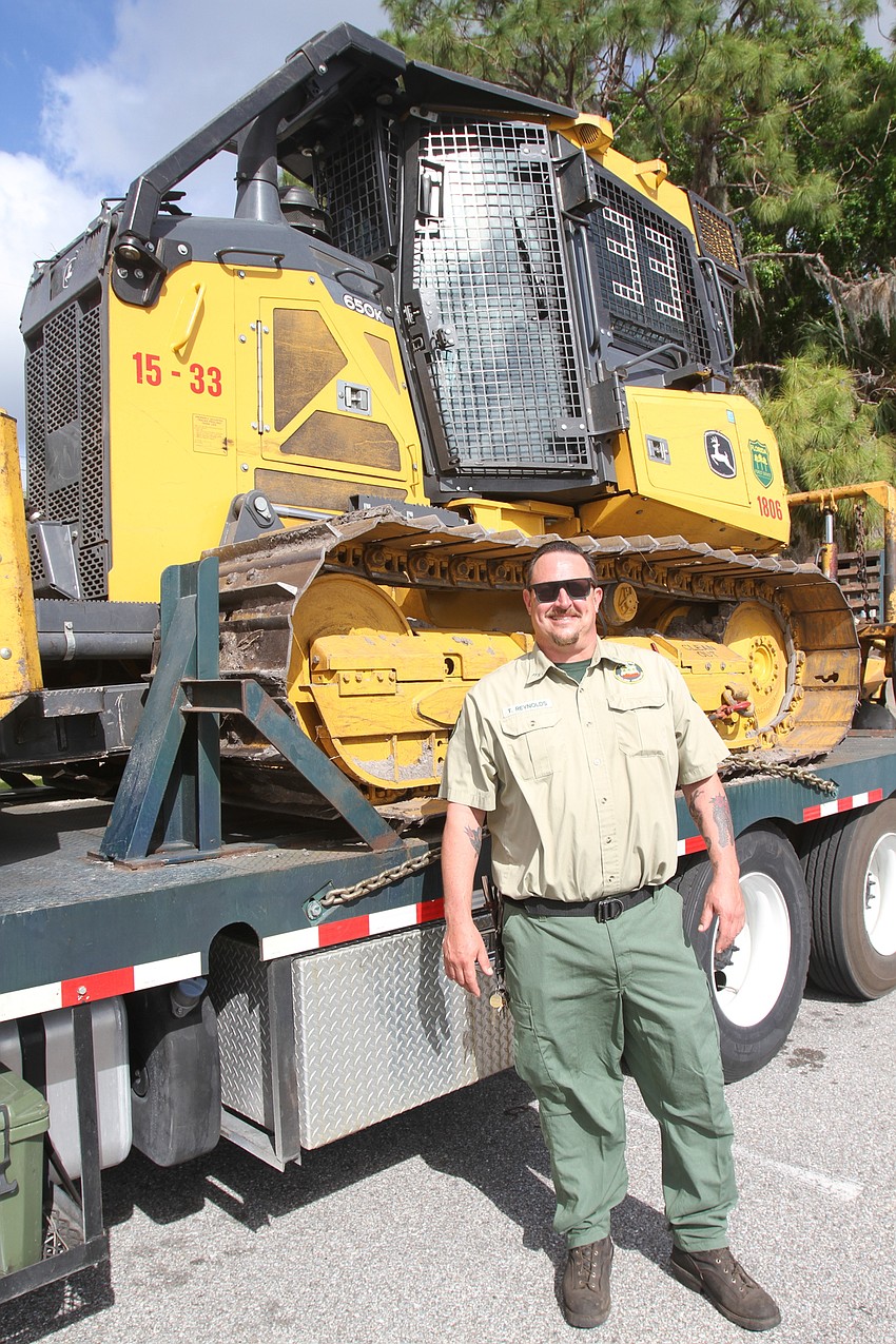 Forest Ranger Tom Reynolds gives facts on a bulldozer.