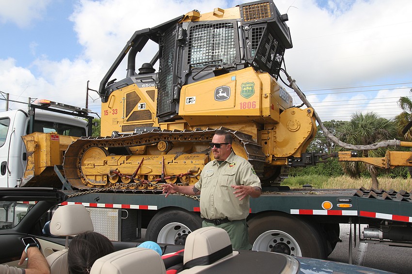 Forest Ranger Tom Reynolds gives facts on a bulldozer.