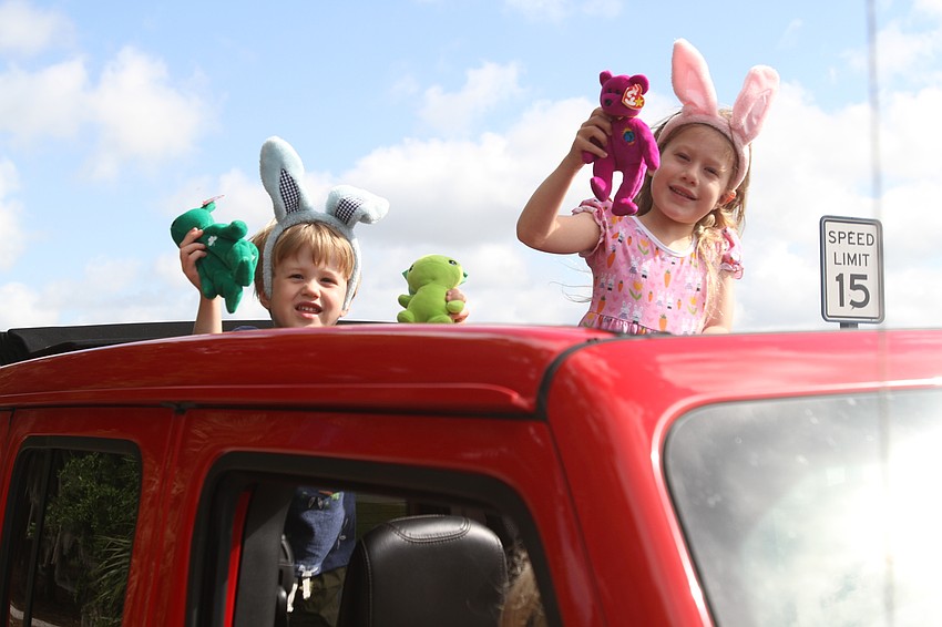 Lakewood Ranch kids Palmer and Emma Naumann play with plush dolls.