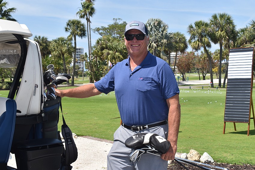 Pat Dunn loads his golf cart.