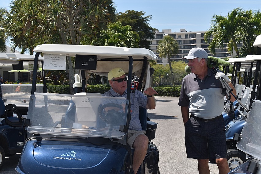 James Malik, right, chats with Steve Thomas before Thomas heads out to the course.