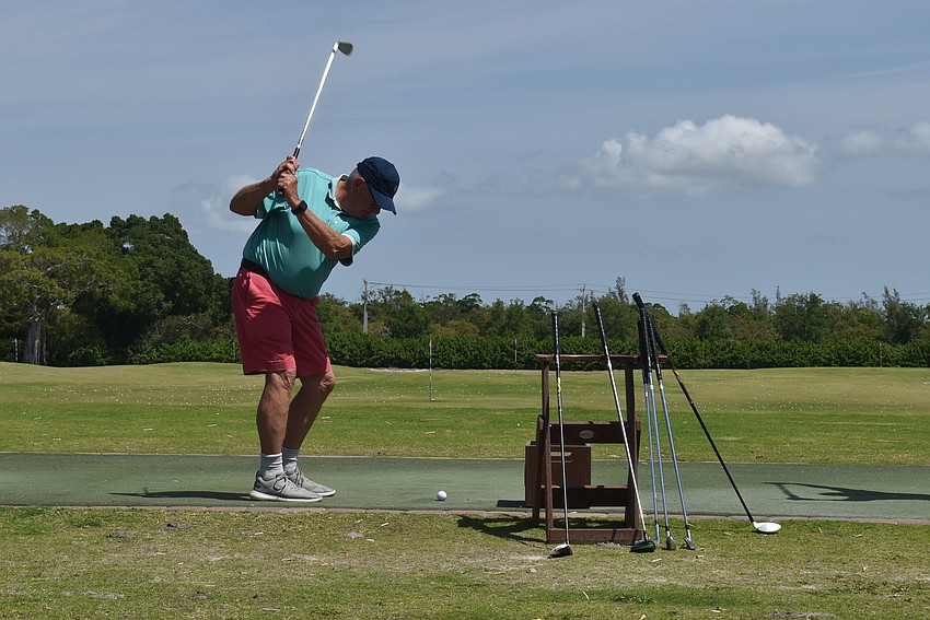 Bob Ellis practices his drive.