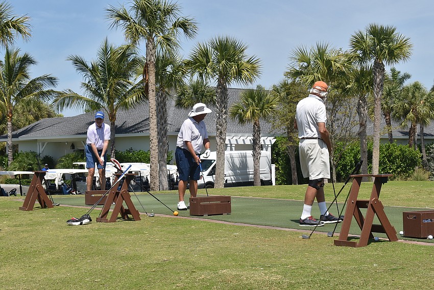 The driving range filled up as more men got ready for the day.