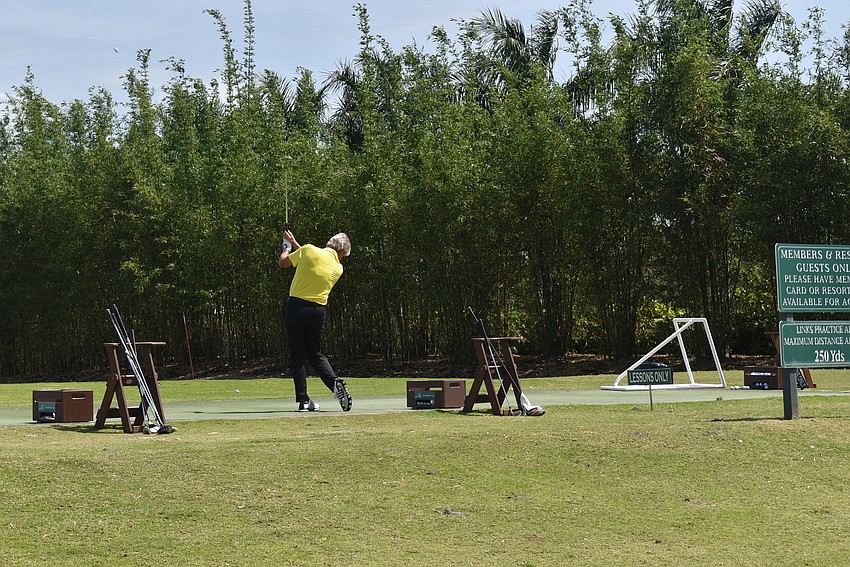 Gary Kirschner gets some practice swings in before the round kicks off.