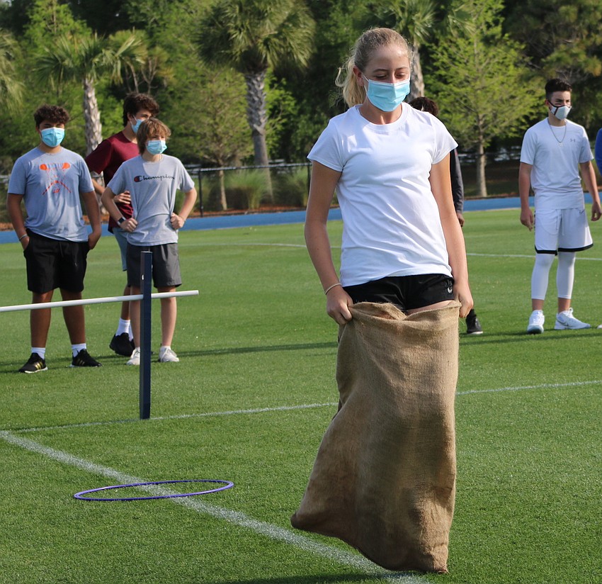 Celia Rayman, en eighth grader, jumps as fast as she can during a sack race. Courtesy photo.