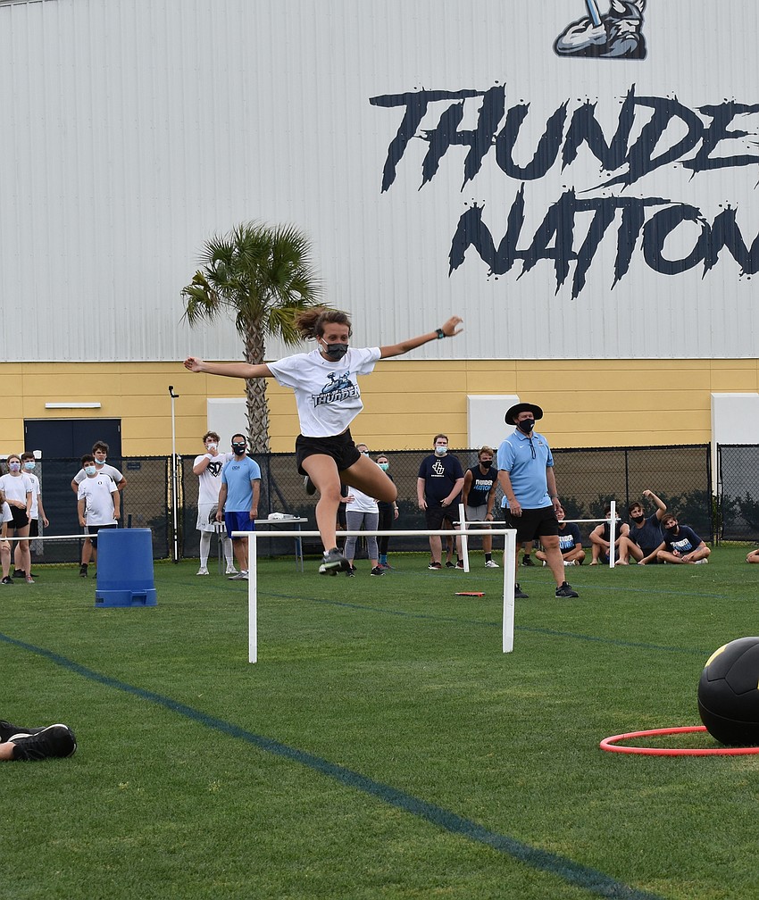 Senior Hailee Toepel goes over hurdles. Courtesy photo.