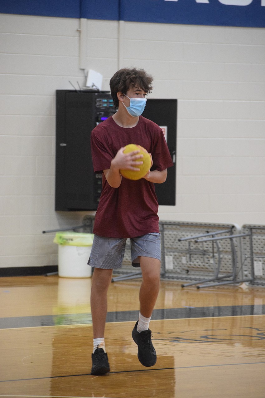 Josey Rubinstein, an eighth grader, decides who his target will be in a game of dodgeball. Photo by Liz Ramos.