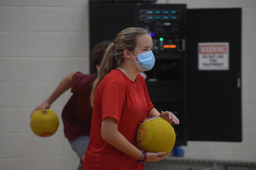 Katherine Triola, an eighth grader, is strategic during a game of dodgeball. Photo by Liz Ramos.