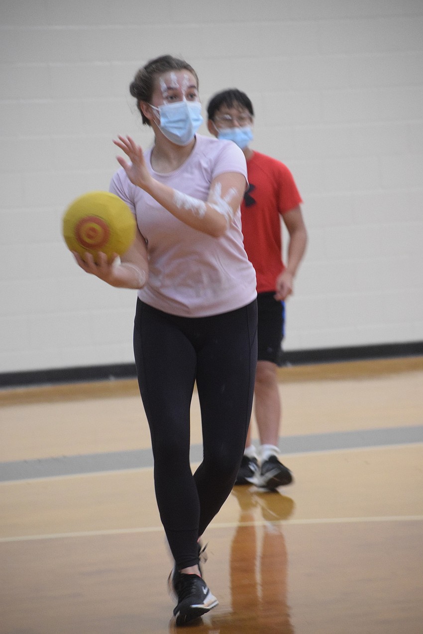 Kristina Spilka, an eighth grader, throws a dodgeball at other eighth graders. Photo by Liz Ramos.