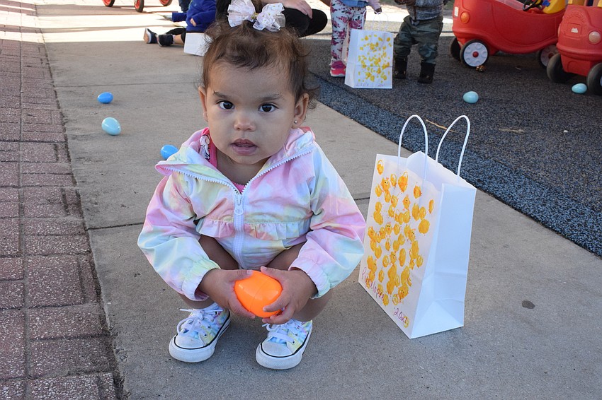 Pynelopee Redmond, who is 1 year old, snatches an egg to add to her collection.