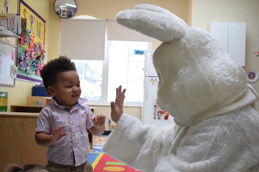 Oliver Dublin high-fives the Easter bunny.