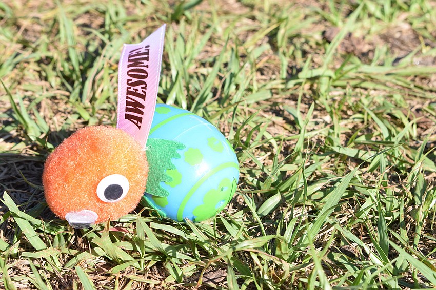 Dozens of eggs are laid out across the playground for children to find.