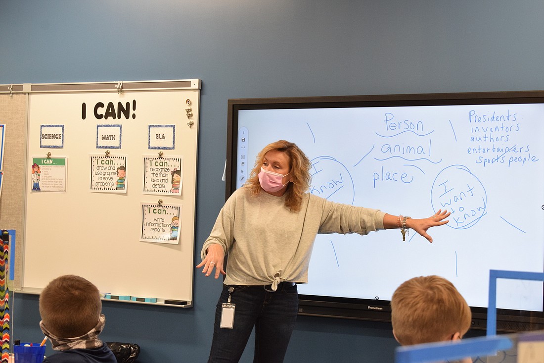 Cheryl Bulfin, a third grade teacher, guides her students through a lesson. All teachers receive a $5,201 supplement from the millage. File photo.