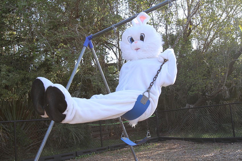 The Easter Bunny takes photos with families.